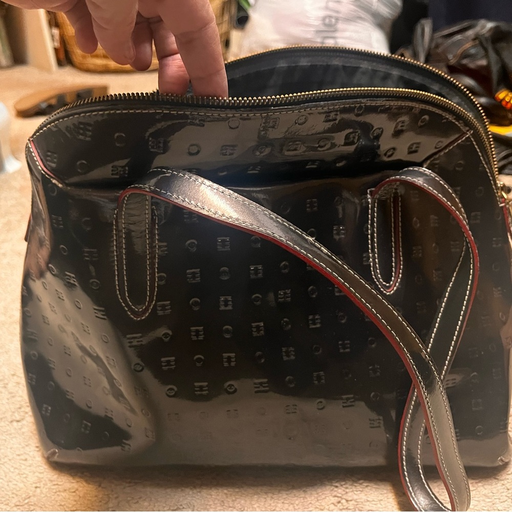 Dark gray patent leather with red details.